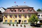 Historisches Hotel und Gasthof Hoftaverne Ziegelböck in Vorchdorf mit gelber Fassade und Blumenschmuck